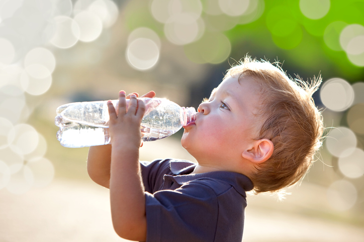 Child drinking water to be healthy