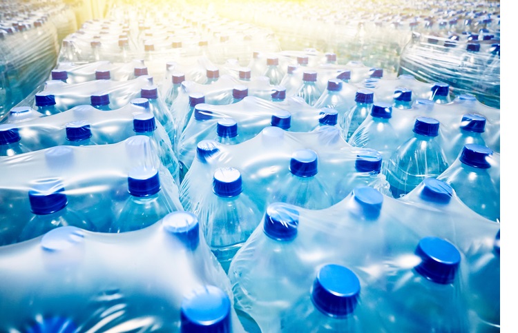 Many packaged blue mineral water bottles