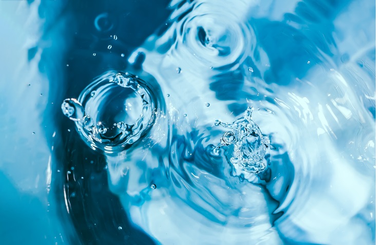Water splash close-up. Drop of water. Blue water drop. Falling water. 