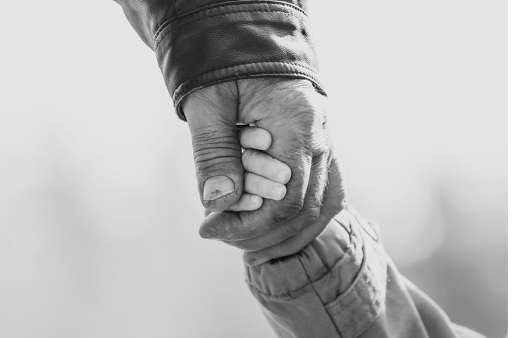 Baby girl warm jacket and cap c grandfather hands in