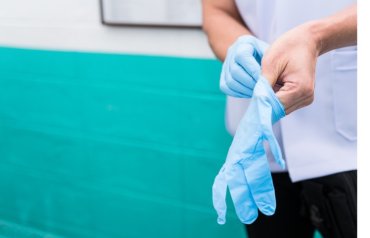 wearing sterile gloves to preparation for treatment