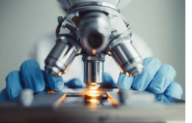 Close up of examining of test sample under the microscope
