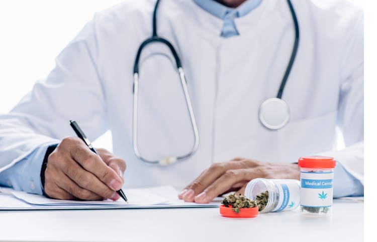 cropped view of doctor in white coat writing isolated on white