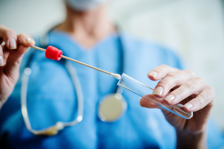 Close up of doctor with sample of saliva from sick woman