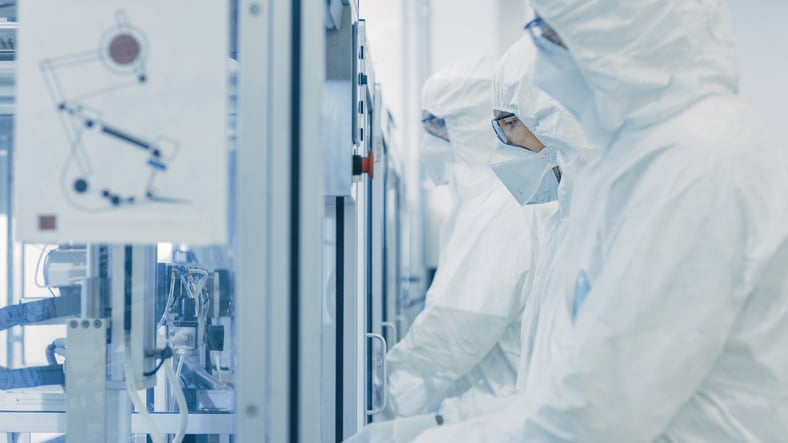 On a Factory Team of Scientists in Sterile Protective Clothing Work on a Modern Industrial 3D Printing Machinery. Pharmaceutical, Biotechnological and Semiconductor Creating / Manufacturing Process