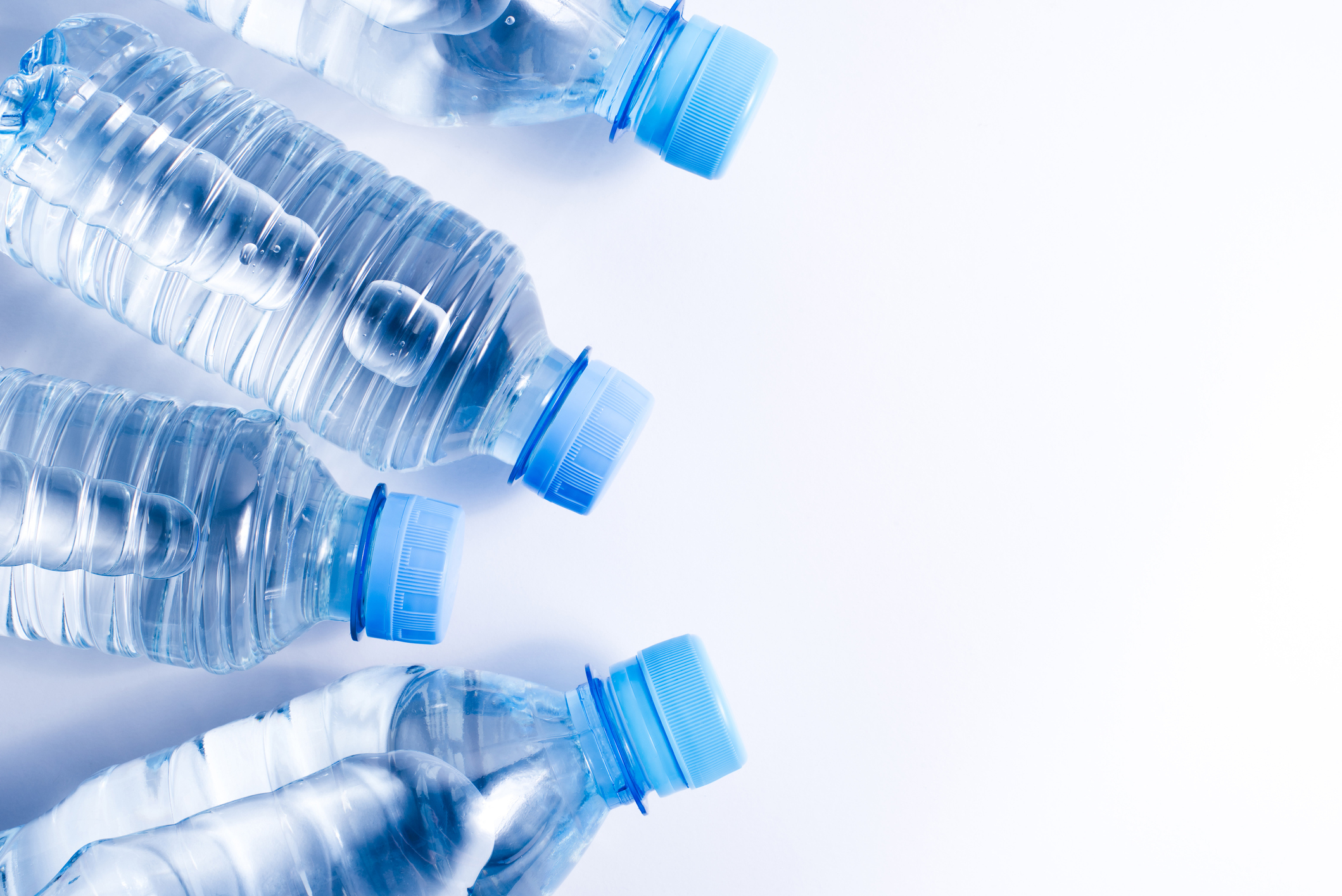 Several drinking water bottles on white background