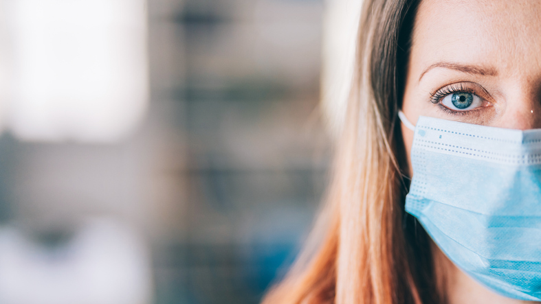 Woman wearing protective face mask in the office for safety and protection