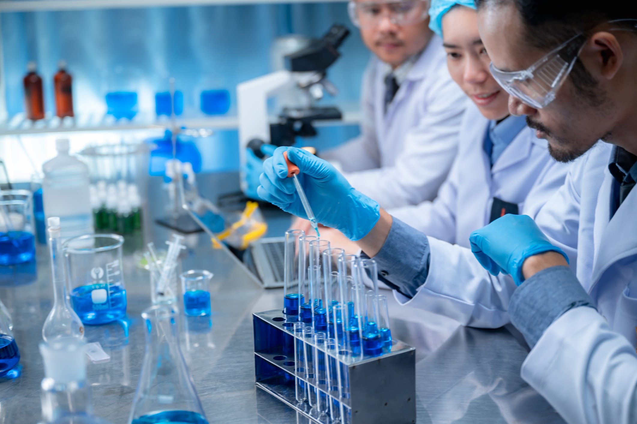 Science and medicine, scientist analyzing and dropping a sample into a glassware, experiments containing chemical liquid in laboratory on glassware, DNA structure, innovative and technology