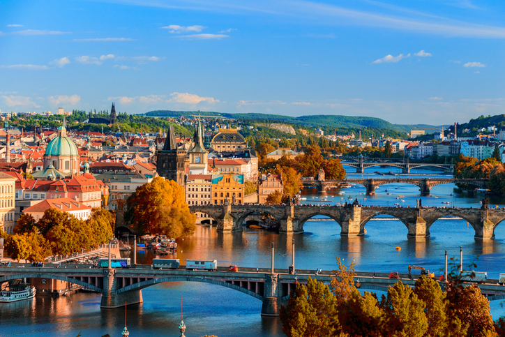 View of the Vltava River and Charle bridge with red foliage, Prague, Czech Republic