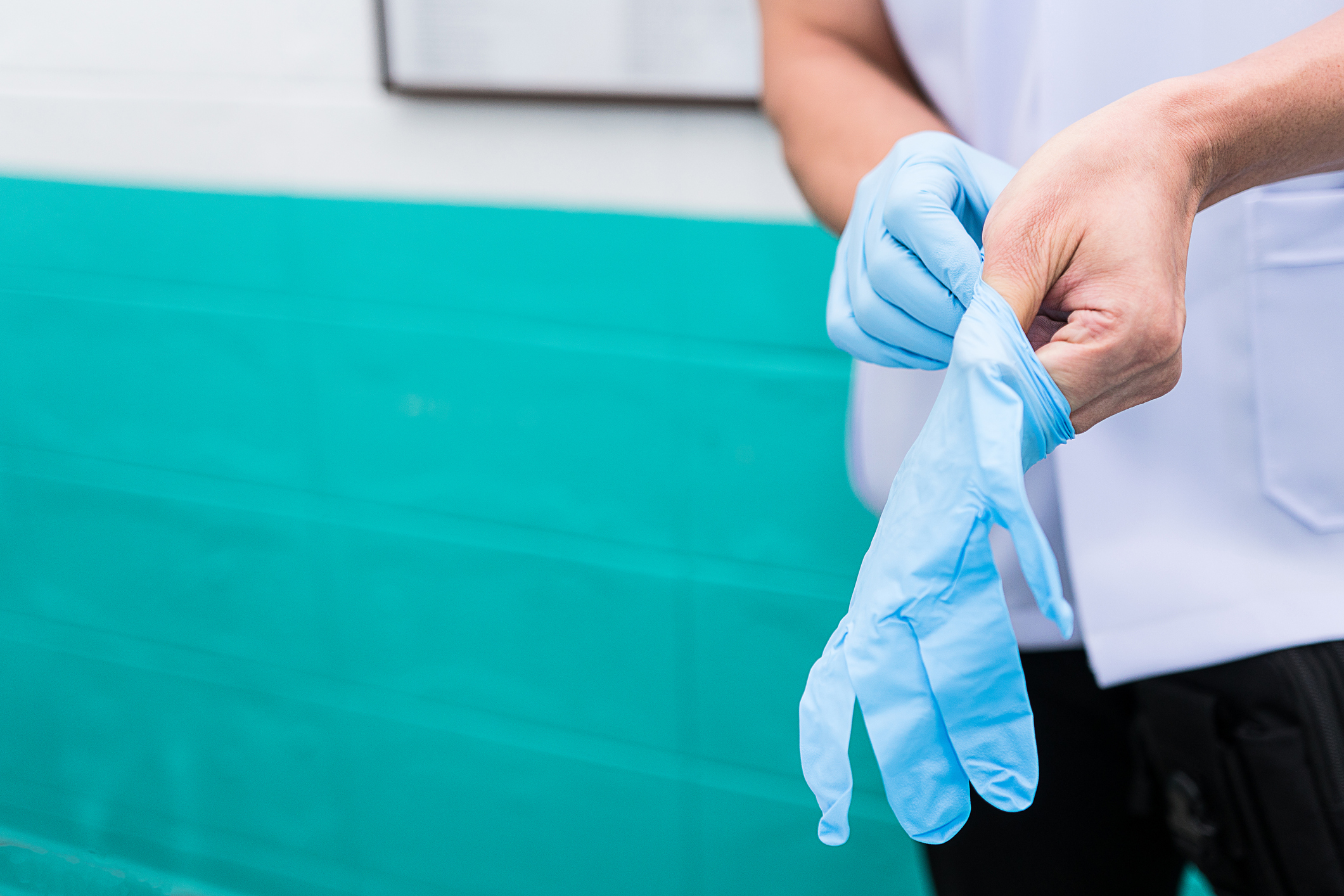 wearing sterile gloves to preparation for treatment
