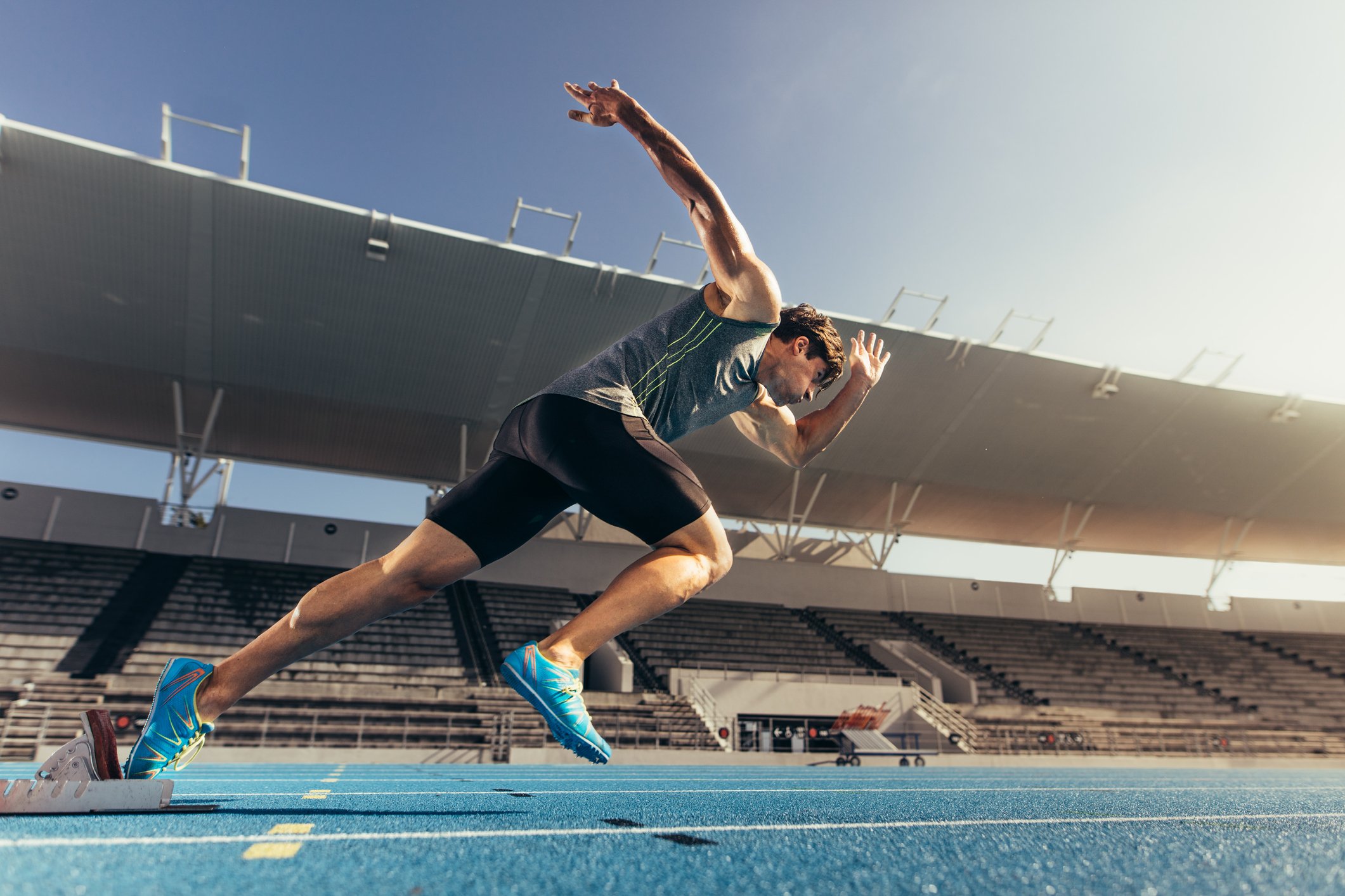 Sprinter taking off from starting block on running track