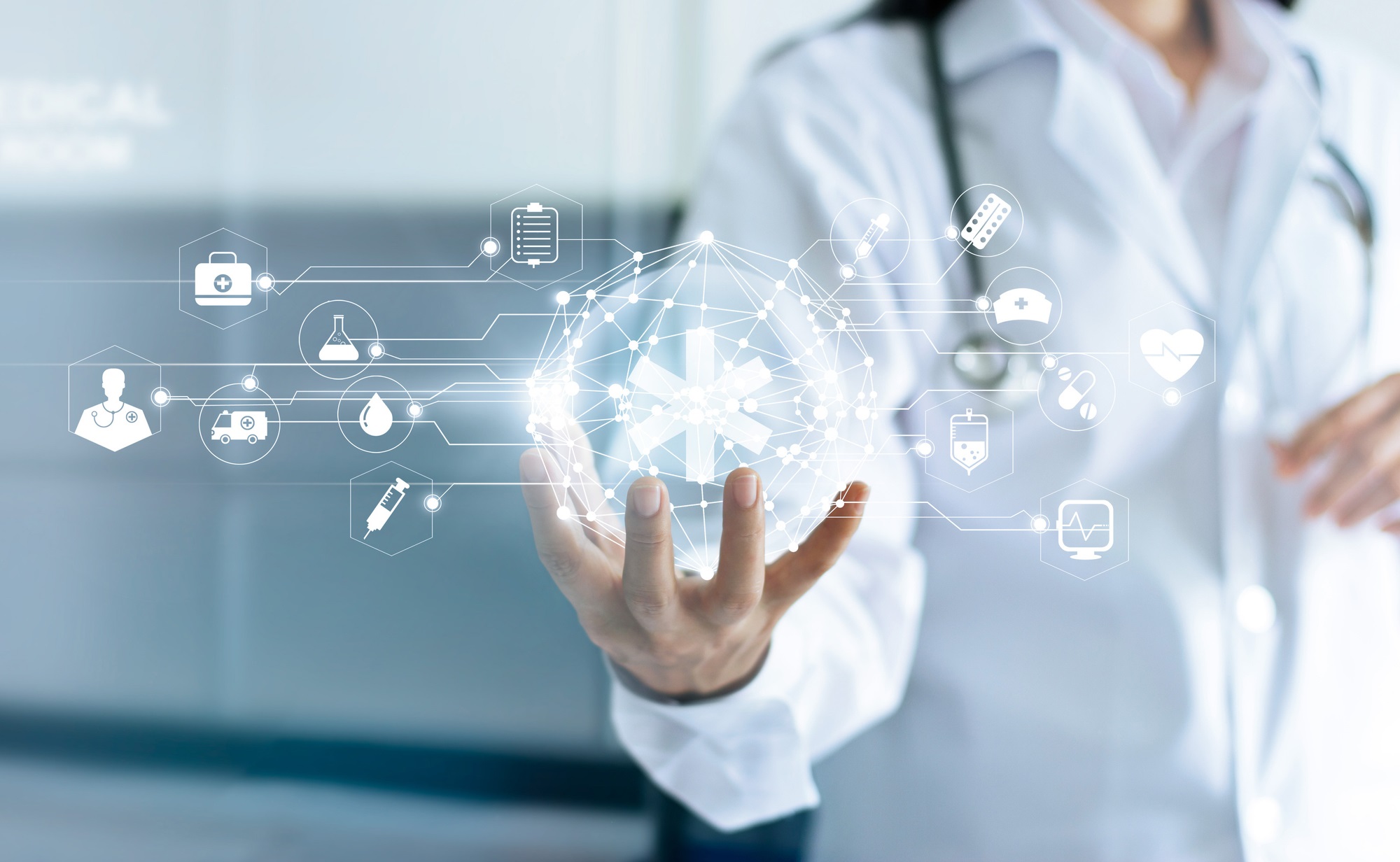 Scientist holding a sphere displaying digital icons relating to science and medicine